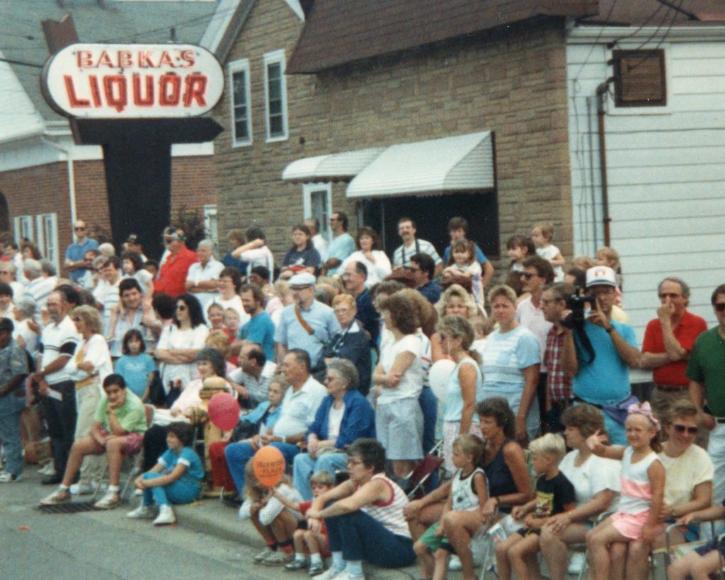 Onlookers gather along the northern end of Public Square as an unseen parade passes by.
